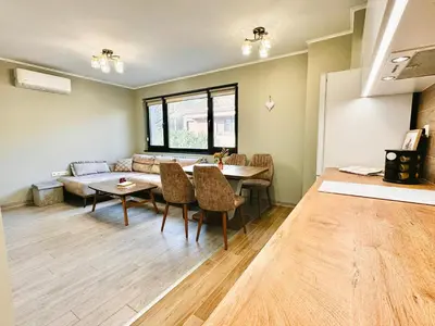 a living room with a table and a couch at Centralside Retreat with Free Parking Spot in Plovdiv