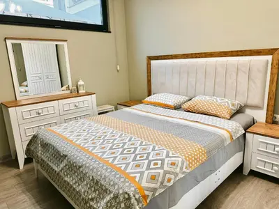 a bedroom with a bed and a dresser and a mirror at Centralside Retreat with Free Parking Spot in Plovdiv