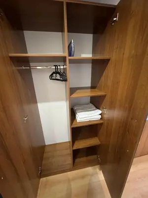 a closet with wooden walls and wooden shelves at Villa Park Borovets in Borovets