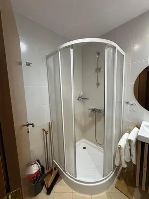 a shower with a glass door in a bathroom at Villa Park Borovets in Borovets