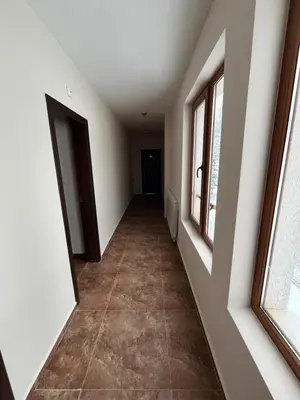 an empty hallway in a house with windows at Hotel Rodope in Pamporovo