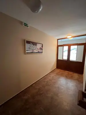 an empty room with a door and a picture on the wall at Hotel Rodope in Pamporovo