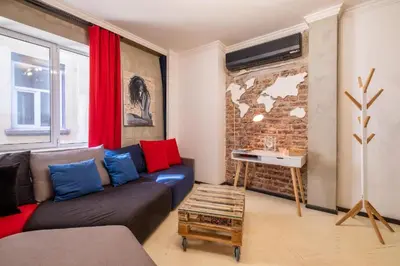 a living room with a couch and a brick wall at 2 Apartments 15 Seconds from Main street in Sofia