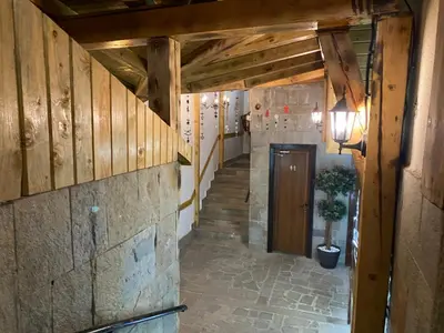 a hallway with a staircase in a building with wooden walls at Castle Inn Pamporovo 2 Bedroom Apartment in Pamporovo