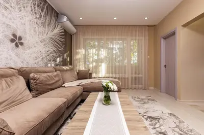 a living room with a couch and a table at South Beautiful Apartment Vaptsarov in Plovdiv