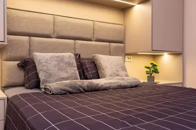 a bedroom with a large bed with two pillows at South Beautiful Apartment Vaptsarov in Plovdiv
