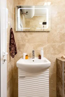 a bathroom with a white sink and a mirror at South Beautiful Apartment Vaptsarov in Plovdiv