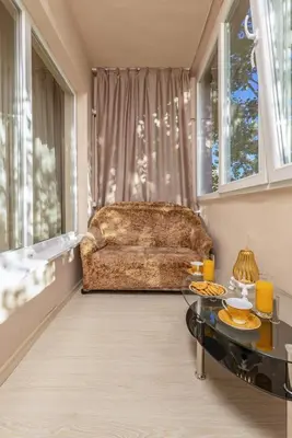 a living room with a couch and a table at South Beautiful Apartment Vaptsarov in Plovdiv