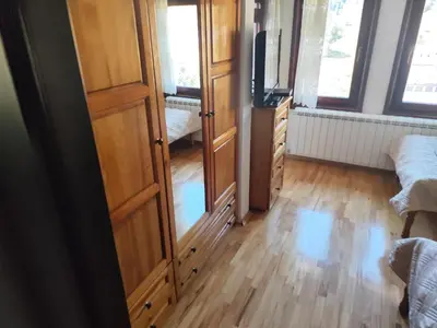 a room with a tv and a wooden floor at Къща за гости Свети Георги in Pamporovo