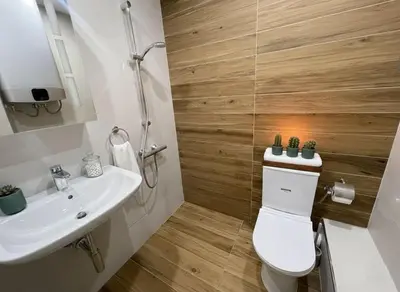 a bathroom with a toilet and a sink at Cozy Central Apartment-Welcome Coffee and Wine in Sofia
