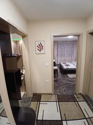 a room with a living room and a room with a couch at Estrella Apartment in Velingrad