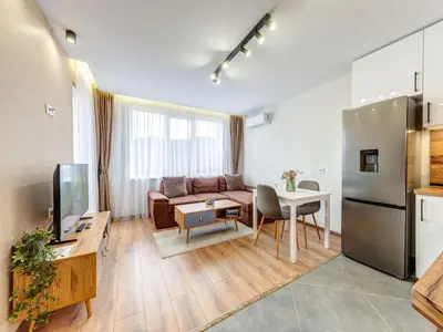 a living room with a couch and a table at Stylish 1BR in the Heart of Town in Smolyan