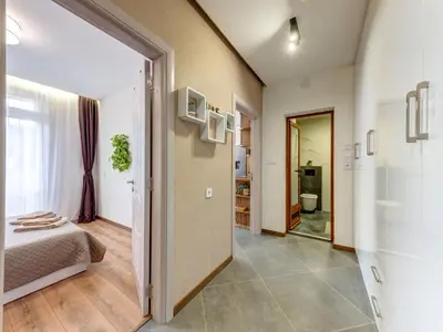 a room with a bed and a door to a bathroom at Stylish 1BR in the Heart of Town in Smolyan