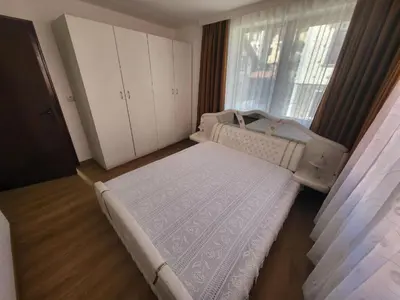a small bedroom with a bed and a window at Къща за гости Йони in Teteven