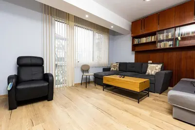 a living room with a couch and a chair at Cozy Floor from a House Near the City Center by Flat Mаnager in Plovdiv