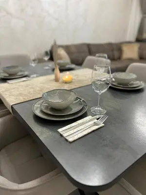 a black table with plates and wine glasses on it at Le bijou Lauta Forest in Plovdiv