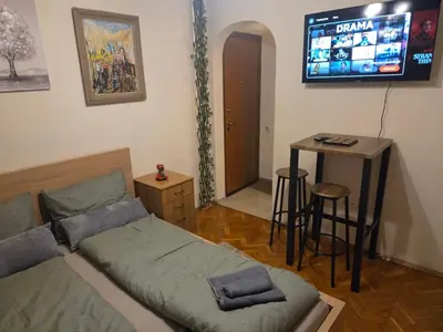 a bedroom with a bed and a table and a television at Smart Budget Stay at Sofia Centre by NDK and Vitosha Blvd in Sofia
