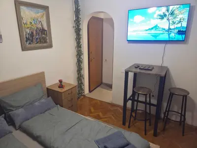 a bedroom with a bed and a table and a desk at Smart Budget Stay at Sofia Centre by NDK and Vitosha Blvd in Sofia