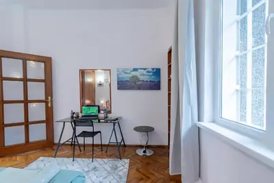 a room with a desk with a laptop on it at Two Vintage Apartments by NDK and Vitosha Blvd with Free Parking in Sofia