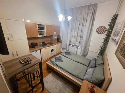 a small room with a bed and a kitchen at Three Vintage Apartments by NDK and Vitosha Blvd with Free Parking in Sofia