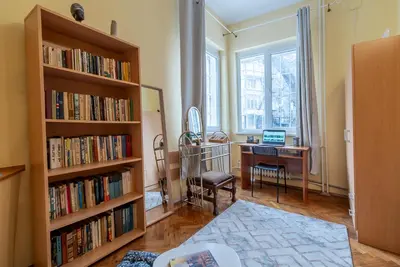 a room with a desk and book shelves filled with books at Three Vintage Apartments by NDK and Vitosha Blvd with Free Parking in Sofia
