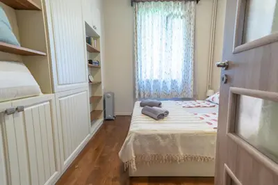 a small bedroom with a bed and a window at Three Vintage Apartments by NDK and Vitosha Blvd with Free Parking in Sofia