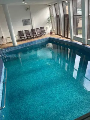 a large swimming pool with blue water in a building at The View Bansko in Bansko