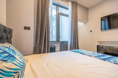 a bedroom with a bed and a window at Stylish 2BDRM Apartment in the Very Heart of Sofia in Sofia