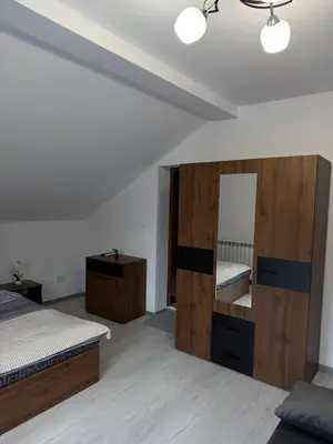 a bedroom with two beds and a large mirror at Bianca Guest House Sapareva banya in Sapareva Banya