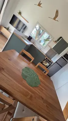 a dining room with a wooden table and chairs at Cottage for 4 people 30 in Sofia