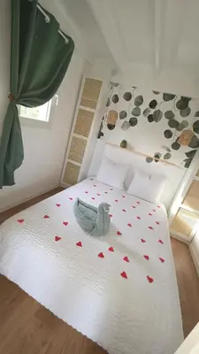 a bedroom with a bed with hearts on it at Cottage for 4 people 30 in Sofia