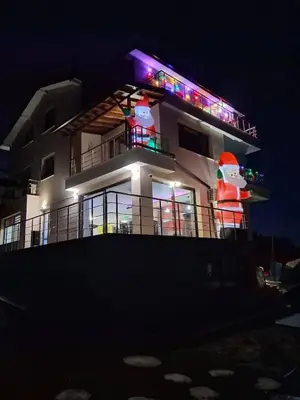 a building with lights on top of it at night at Guest House Vanessa 2 in Gulubovo