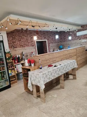 a kitchen with a table in a room at Guest House Vanessa 2 in Gulubovo
