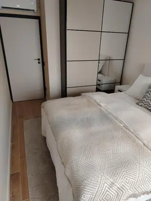 a bedroom with a white bed and two sliding doors at AMur Deluxe Apartment in Sofia