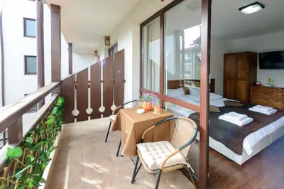 a balcony with a bed and a table and chairs at Your studio at Winslow Infinity in Bansko