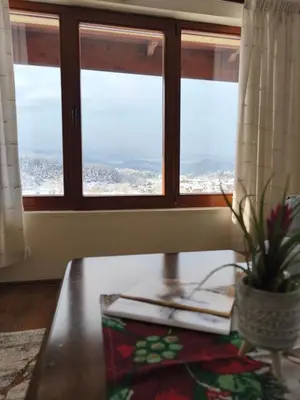 a room with a table and a window at Къща за гости Рилски рай in Samokov