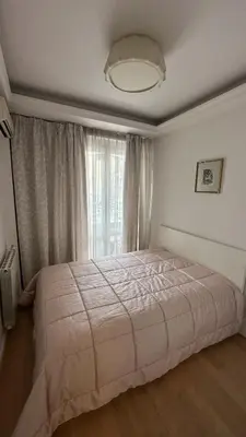 a bedroom with a large bed with a window at Bonnie's Stylsih 2BR Home near the Palace in Sofia
