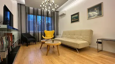 a living room with a couch and a table at Bonnie's Stylsih 2BR Home near the Palace in Sofia