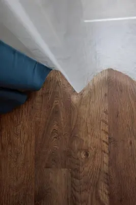 a wooden floor with a white sheet on top of it at Trafi Em in Sofia