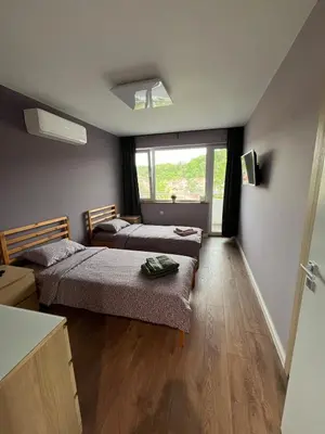 a small room with two beds and a window at Green view 180 in Troyan