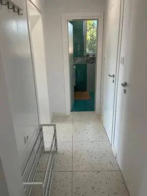 a bathroom with a mirror and a tiled floor at Green view 180 in Troyan