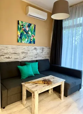 a living room with a couch and a table at Flower home 1 in Sofia