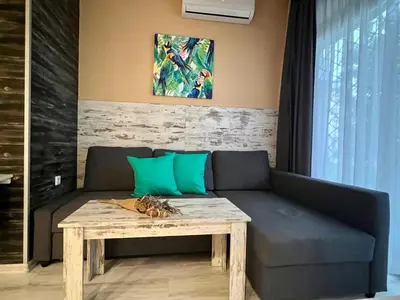 a living room with a couch and a table at Flower home 1 in Sofia