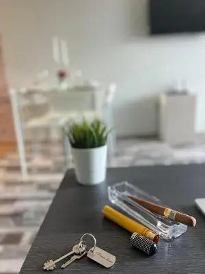 a table with a pair of keys and a pen at Flower home 2 in Sofia