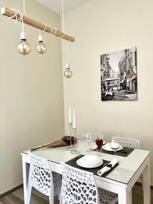 a dining room with a white table and chairs at Flower home 4 in Sofia