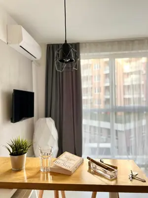 a wooden table with a book on it next to a window at Flower home 5 in Sofia