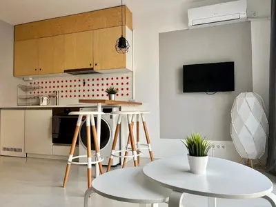 a kitchen with white tables and stools at Flower home 5 in Sofia