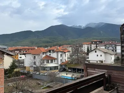 a view of a city with buildings and mountains at Deluxe Apartment in Bansko