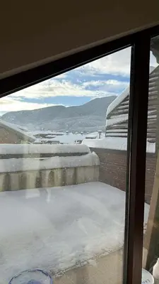 a view from a window of snow on a roof at Deluxe Apartment in Bansko