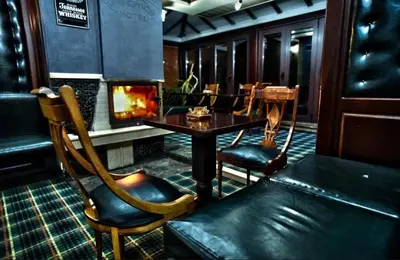 a restaurant with a fireplace and a table and chairs at Deluxe Apartment in Bansko